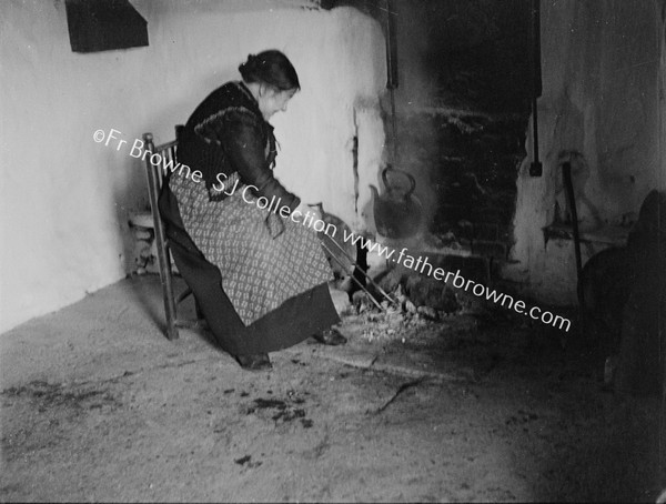 OLD WOMAN AT OPEN HEARTH